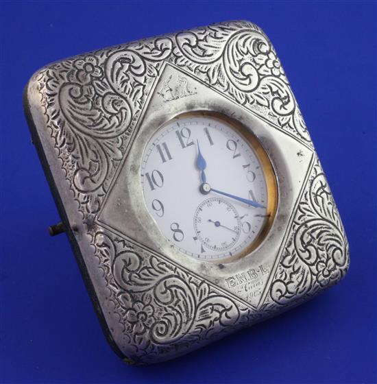 An Edwardian silver mounted travelling watch case, containing a nickel cased pocket watch with Arabic dial, 4in.